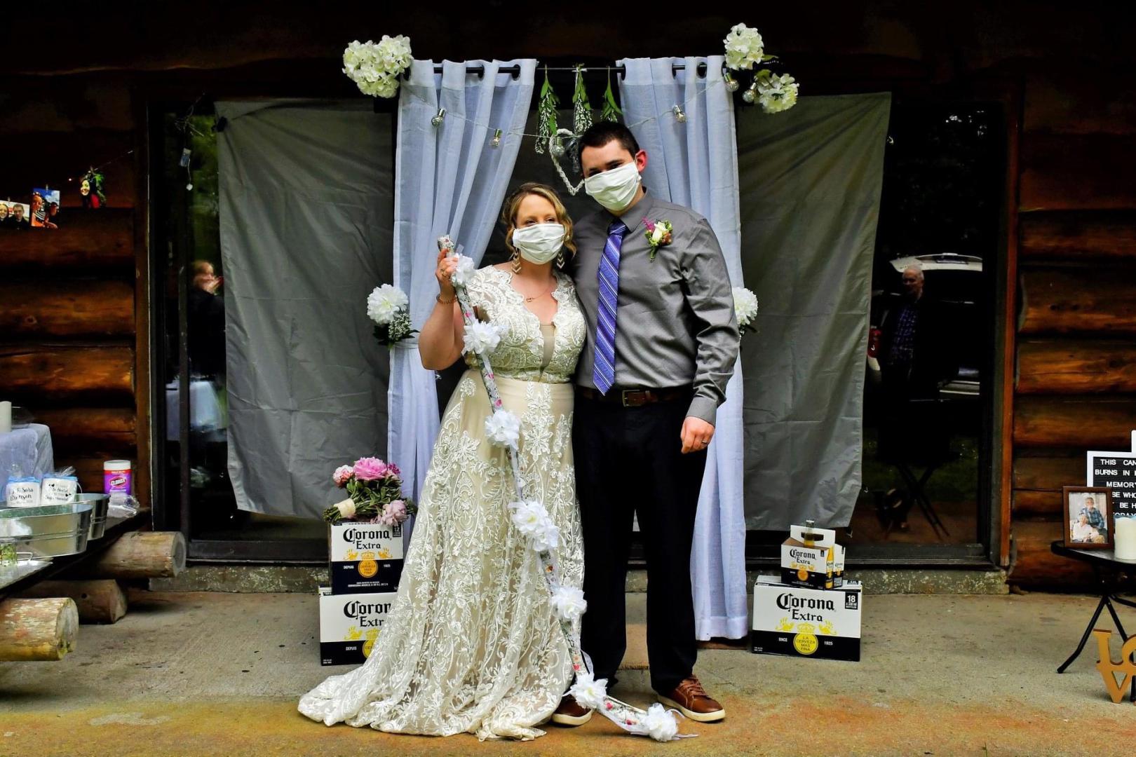 Image of woman and man at a wedding wearing cloth masks.