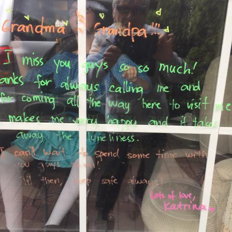 Nancy's daughter seen through a window with a message written on it.