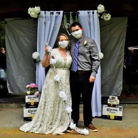 Image of woman and man at a wedding wearing cloth masks.